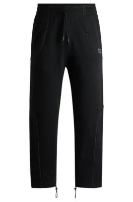 Cotton-terry tracksuit bottoms with decorative reflective trims